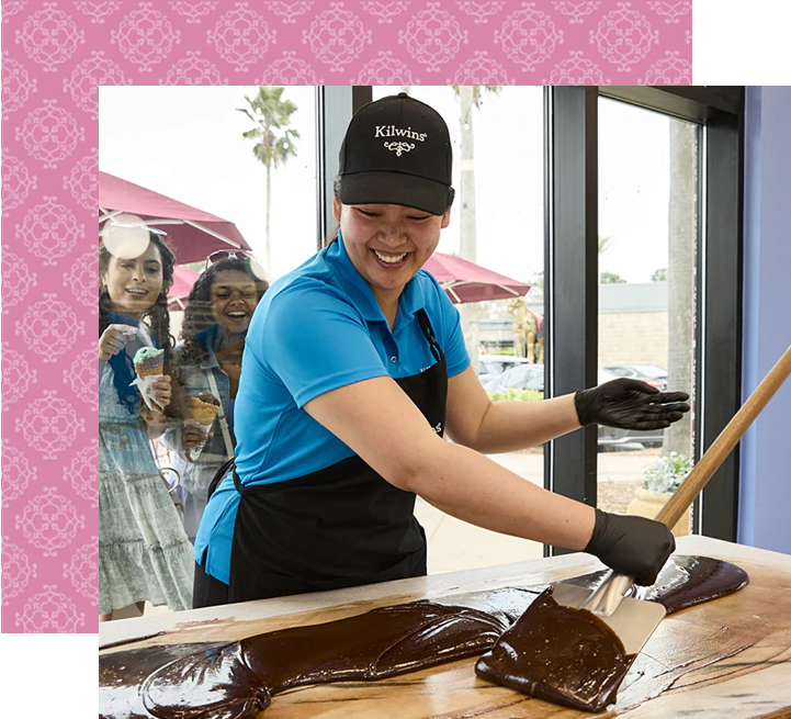 Employee making chocolate fudge at Kilwins shop