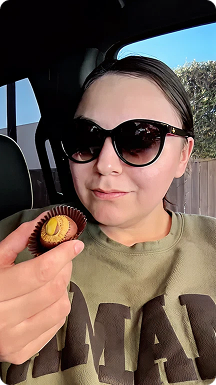 Anna Grigorian in sunglasses about to review a dubai truffle