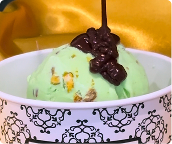 Chocolate syrup drizzling on ice cream for a dubai sundae