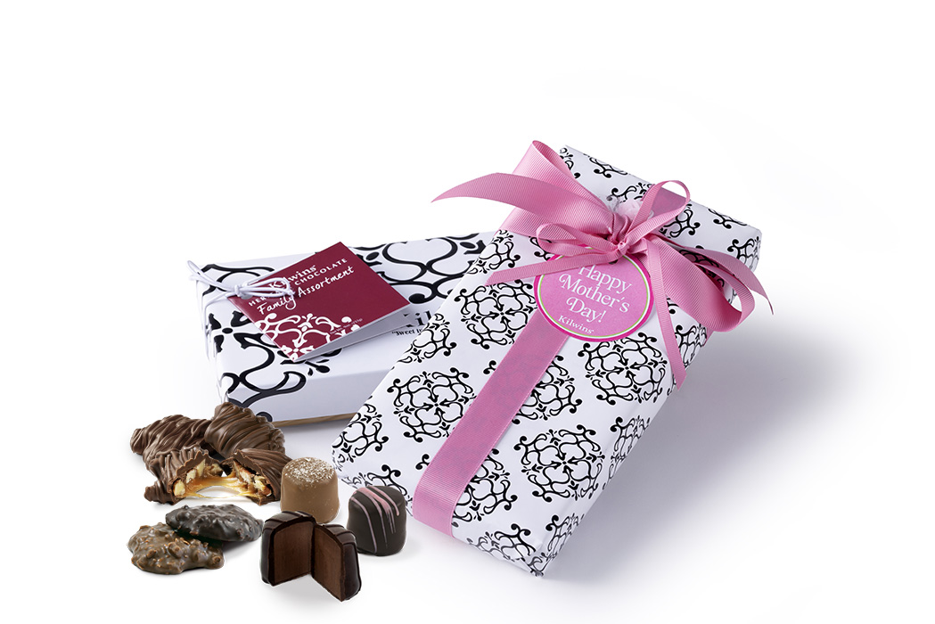 Two boxes of chocolate with loose chocolates in front
