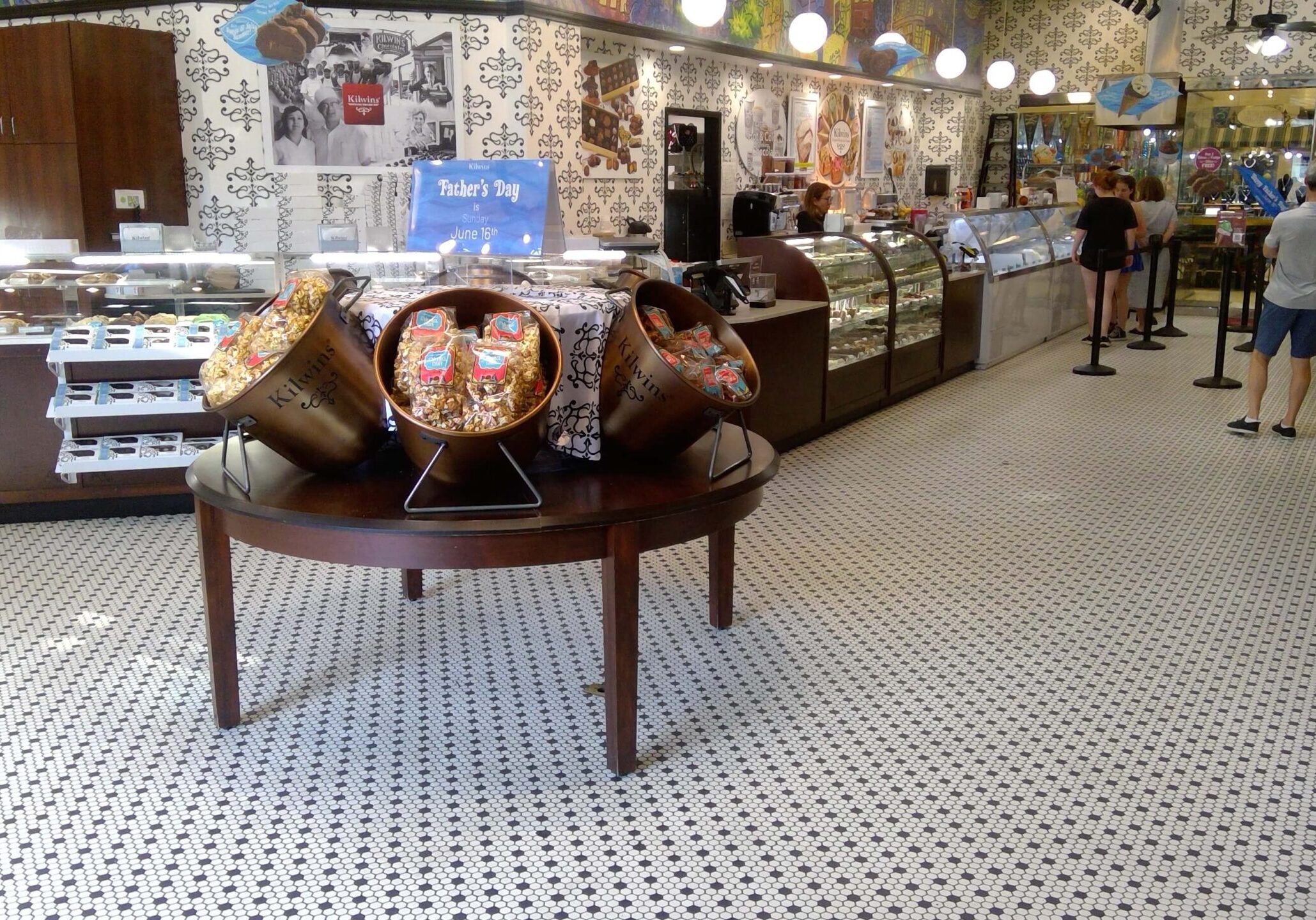 Candy store interior with customers and display cases